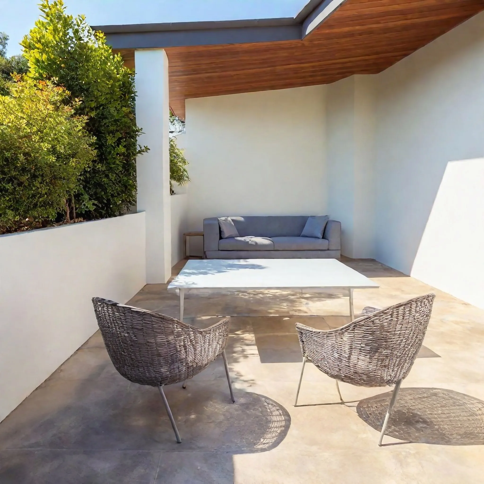 Concrete patio with outdoor furniture set up for entertaining